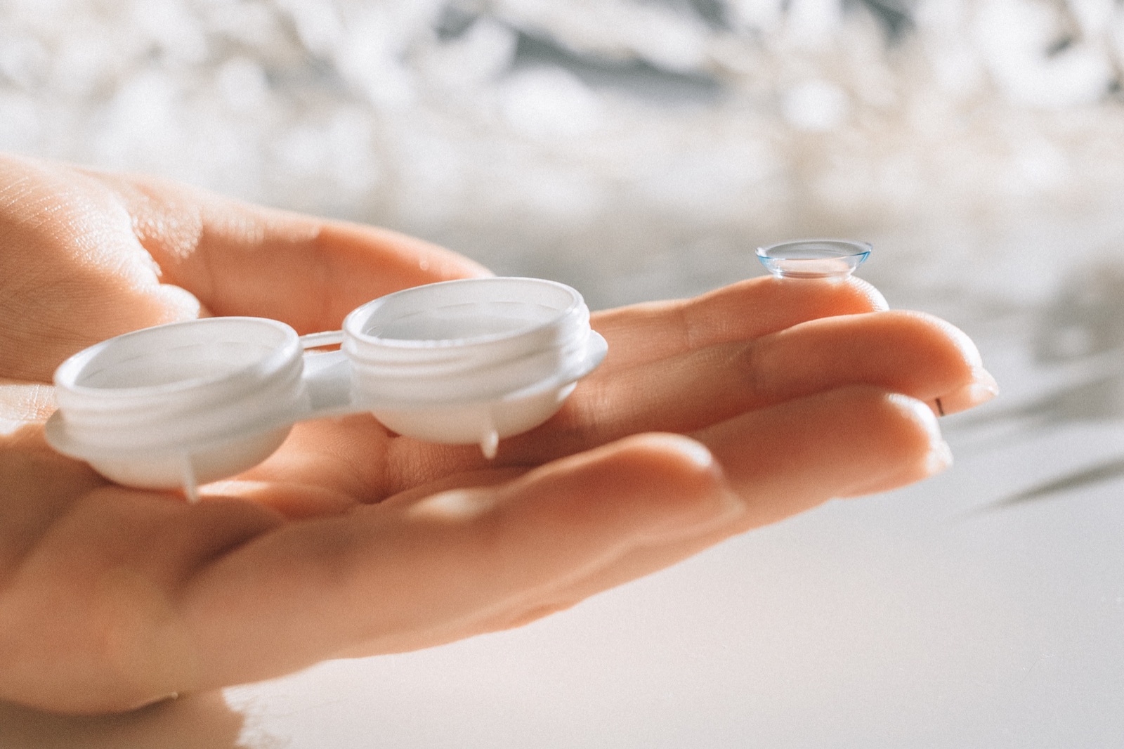 Soft contact lens on a fingertip